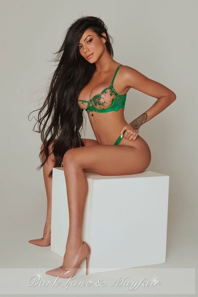 Beautiful escort Dusty showing off her sexy physique in green lingerie