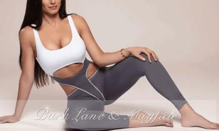 This alluring escort showcases her elegant, lengthy legs.