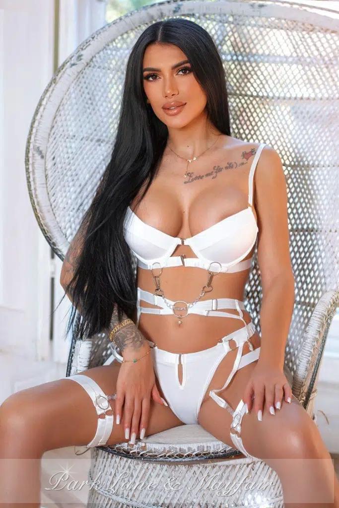 Top London escort exuding confidence and elegance in a naughty photo shoot.