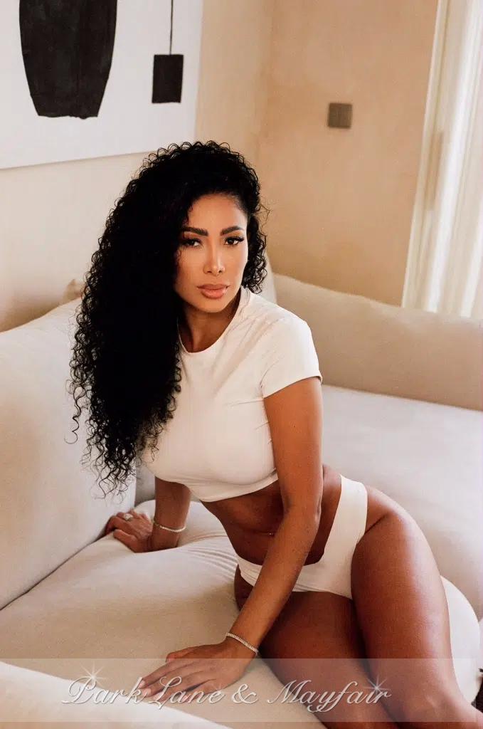 Harmony radiates charm as she confidently showcases her natural beauty.