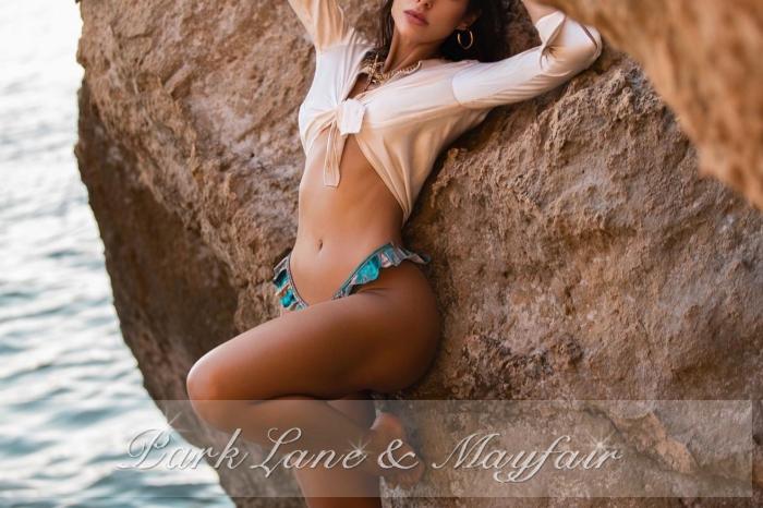 A lovely companion in a stunning gown, radiating elegance and sophistication with every pose.