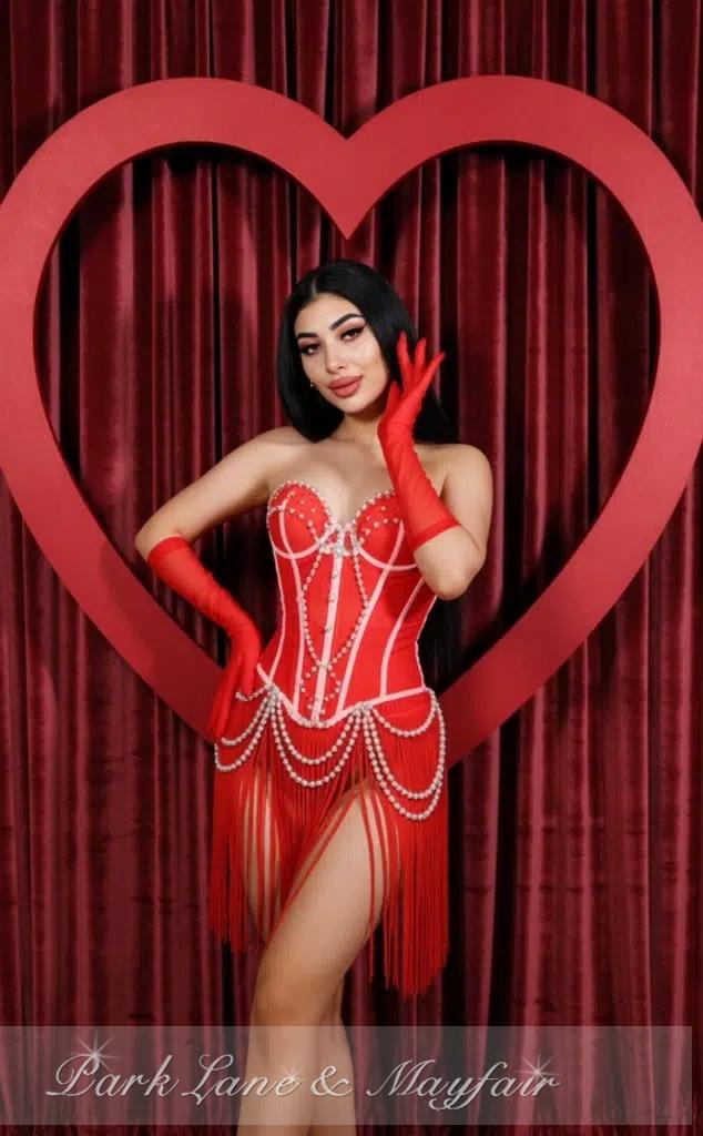 Leoni captivates with her charming pose and radiant eyes that invite you closer.