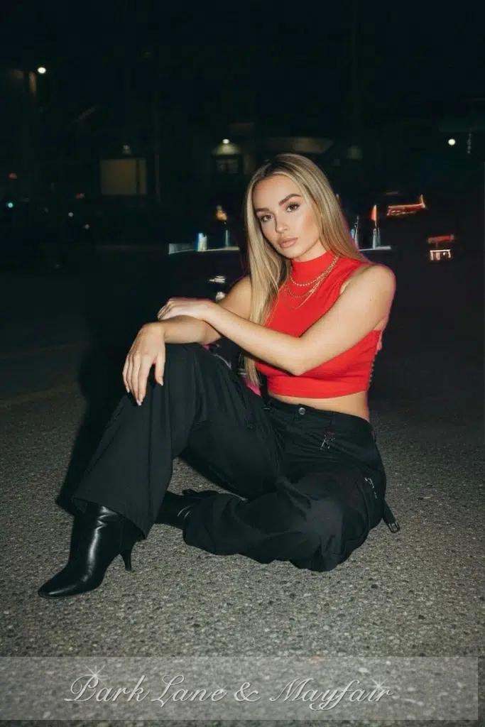 An enchanting woman radiating grace and sophistication in a fashionable ensemble.